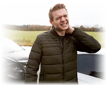 Man holding his neck beside a damaged car