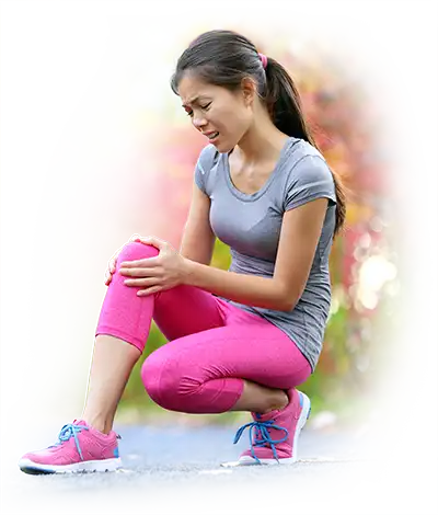 Woman holding her painful knee outdoors